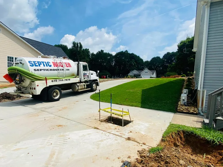 SepticRooter pump truck in a driveway at a repair job