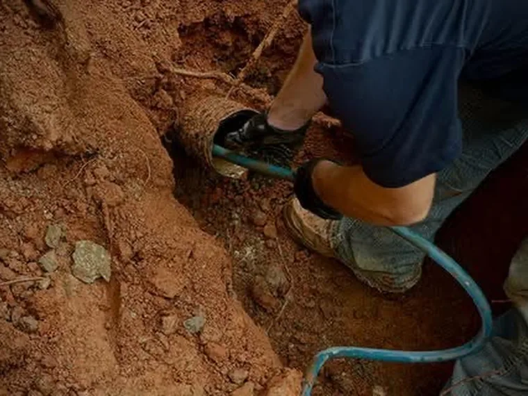 Technician rodding out a septic line during a repair